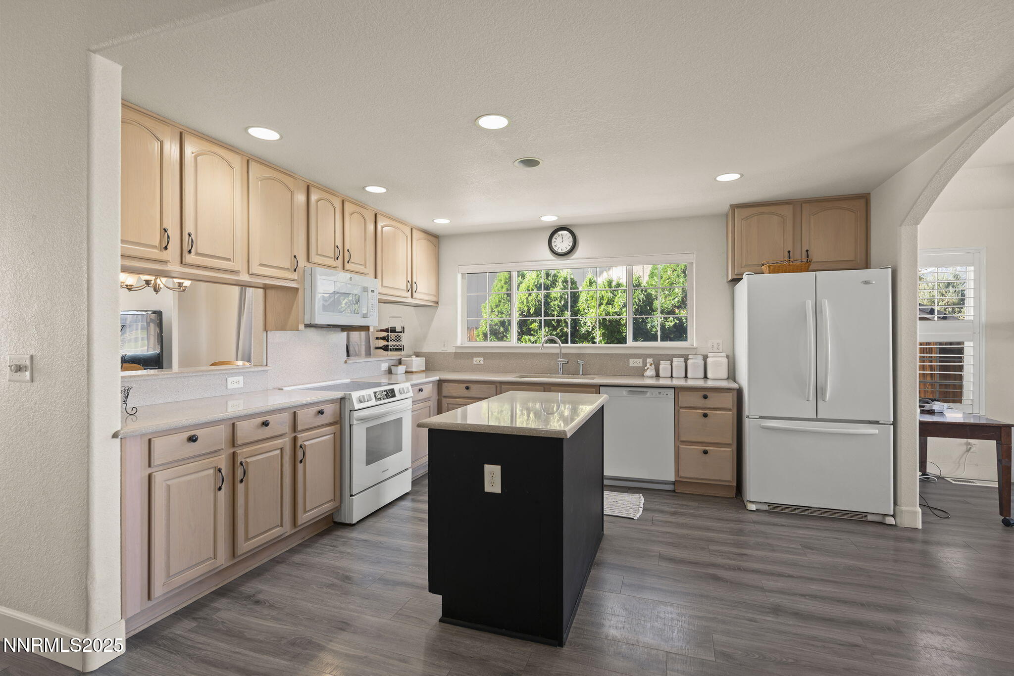 1030 Haystack Drive Carson City, NV 89705 - Photo 9 of 24 a kitchen with stainless steel appliances granite countertop a refrigerator a sink dishwasher a stove and white cabinets with wooden floor