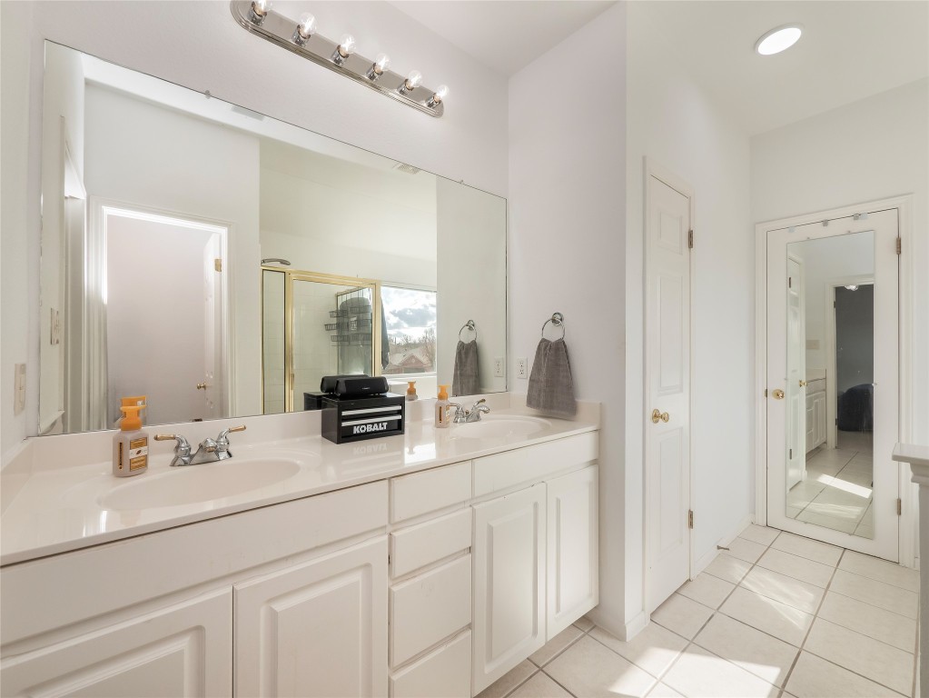 1819 Rutherford Drive Leander, TX 78641 - Photo 23 of 36 a bathroom with a double vanity sink mirror and shower