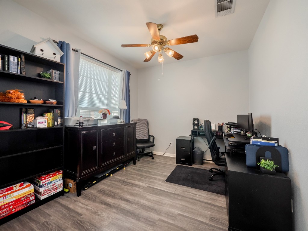 1819 Rutherford Drive Leander, TX 78641 - Photo 6 of 36 a room with a wooden floor and gym equipment