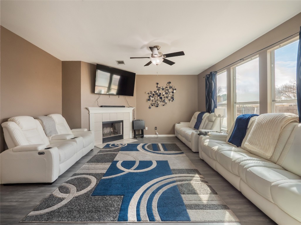 1819 Rutherford Drive Leander, TX 78641 - Photo 8 of 36 a living room with furniture a fireplace and a flat screen tv