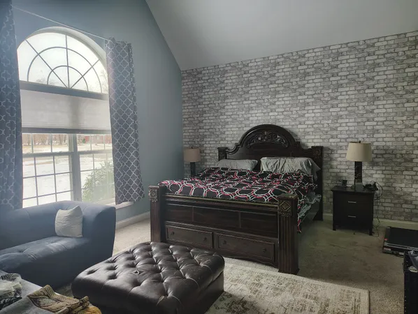 a bed room with a bed and a chair