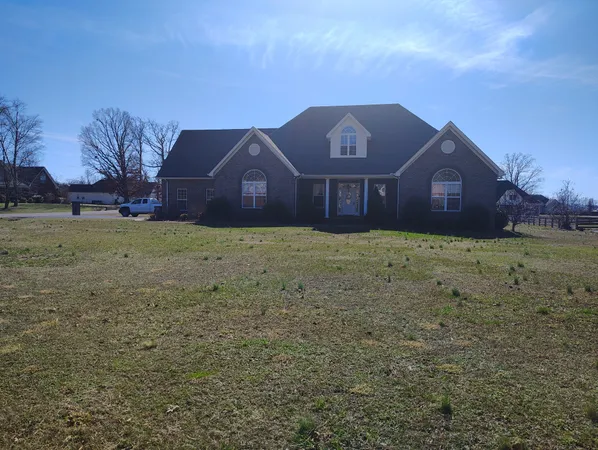 a large house with a big yard and large trees