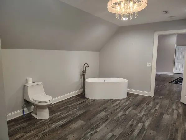 a bathroom with a toilet and a mirror