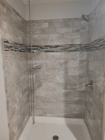a bathroom with a shower and a bathtub