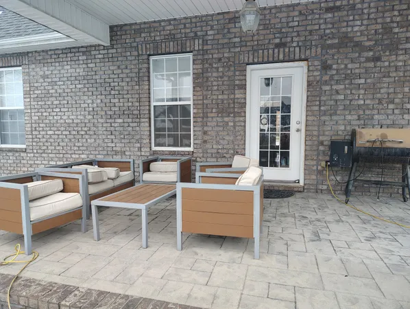 a view of a patio with couches and chairs