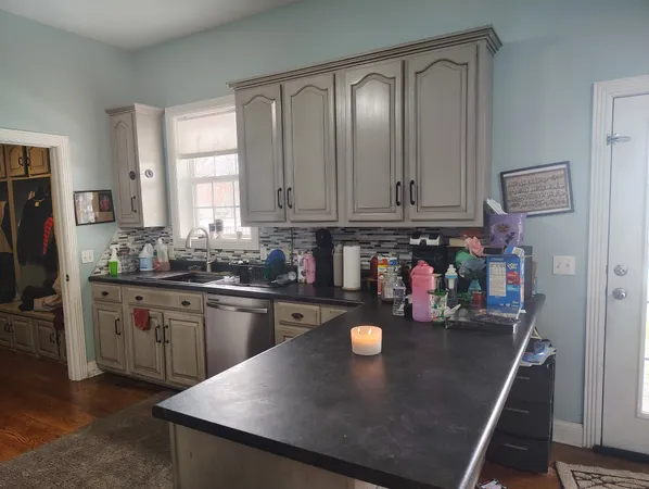 a kitchen with stainless steel appliances granite countertop a sink a stove and a refrigerator