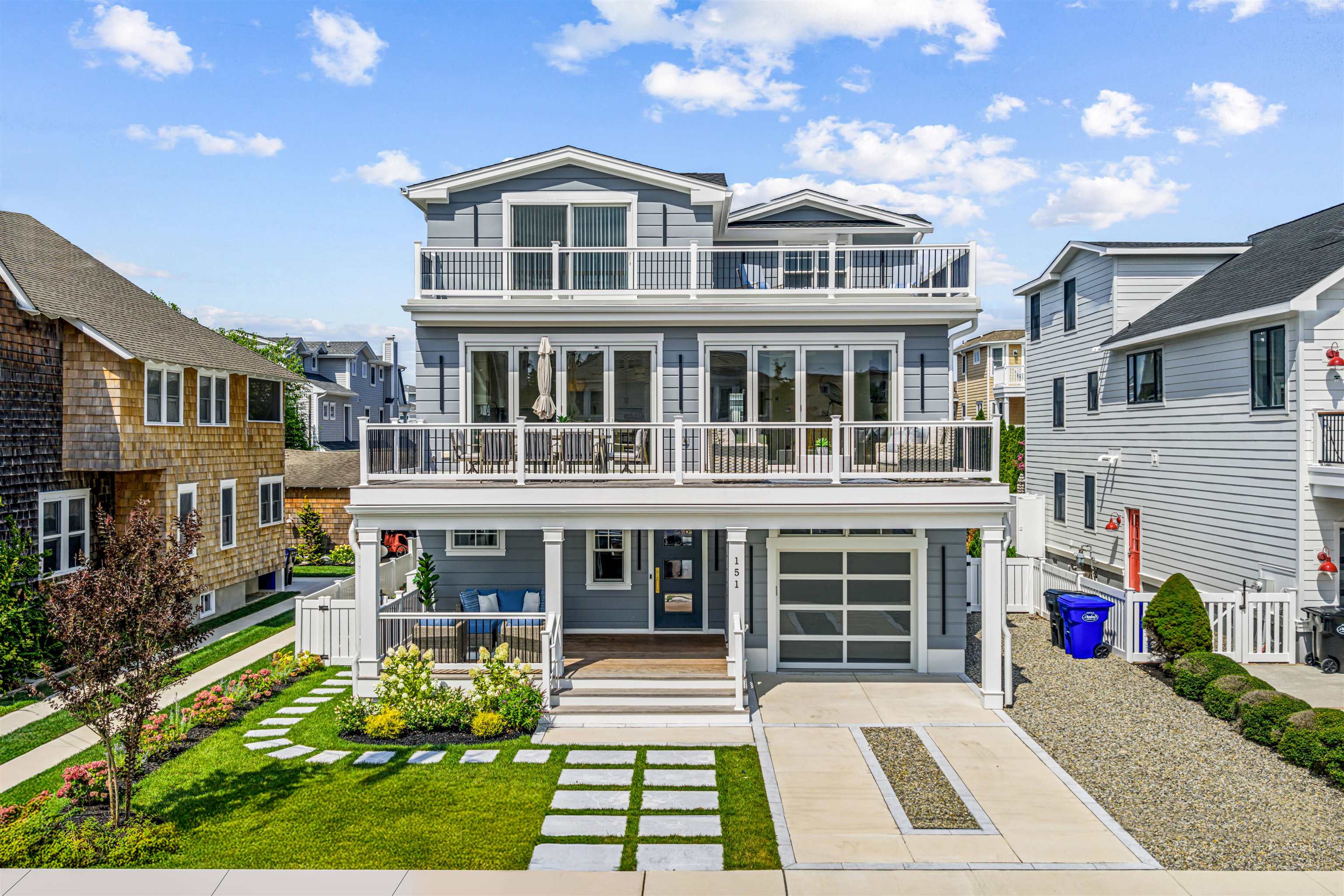 a front view of a building with a garden