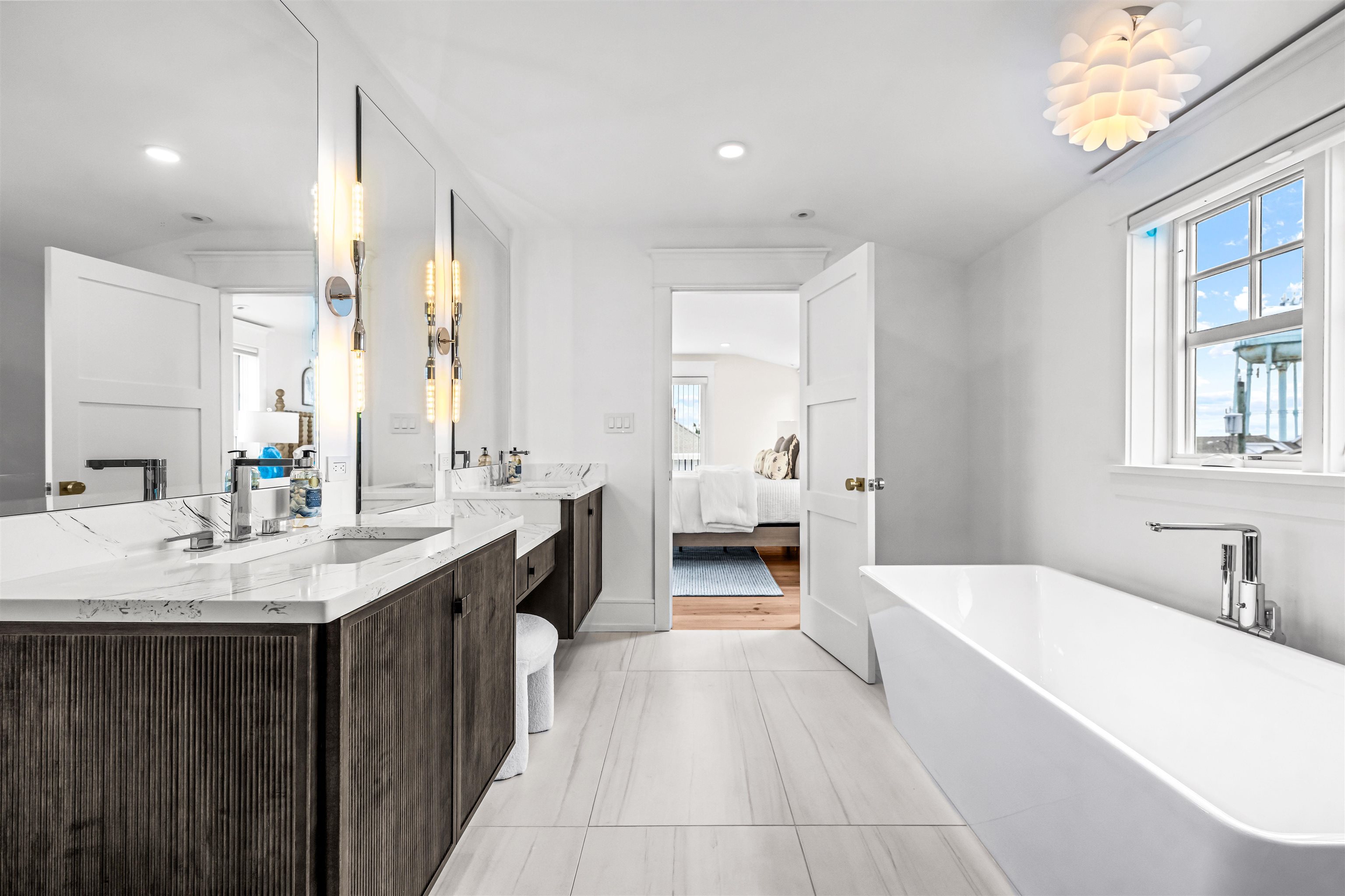 151 37th Street Avalon, NJ 08202 - Photo 43 of 50 a spacious bathroom with a bathtub sink and mirror