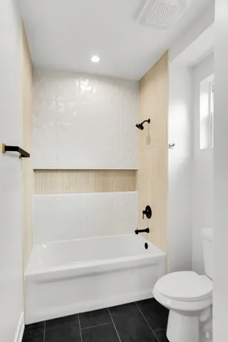 a bathroom with a toilet a sink and a bathtub