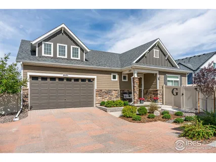 a front view of a house with a yard and outdoor seating