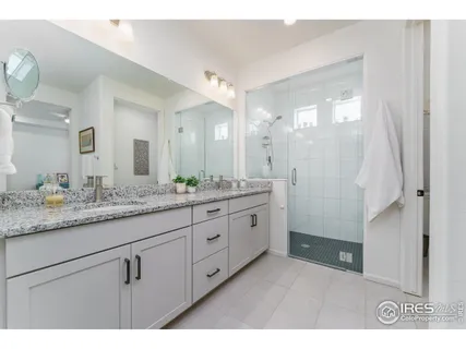 a bathroom with a granite countertop sink mirror and double