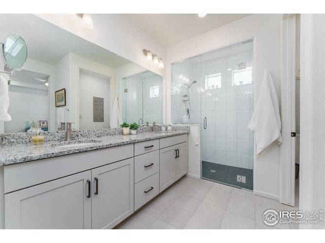 a bathroom with a granite countertop sink mirror and double