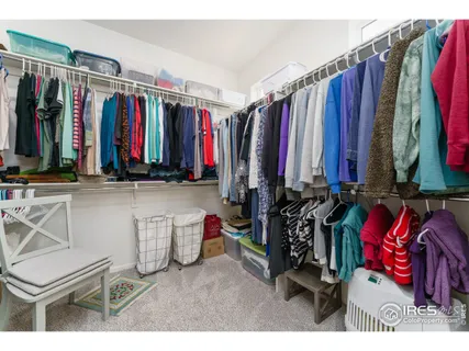 a view of walk in closet with clothes