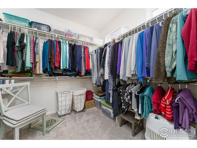 a view of walk in closet with clothes