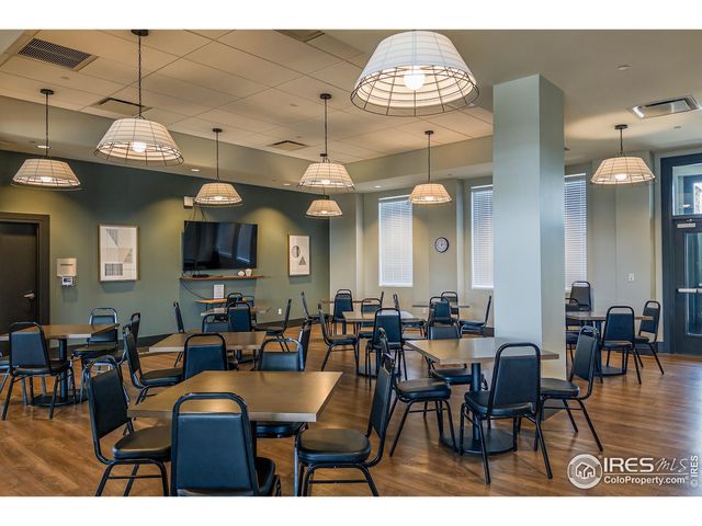 a view of a dining room with furniture a chandelier and wooden floor