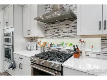 a kitchen with stainless steel appliances granite countertop a stove and a sink