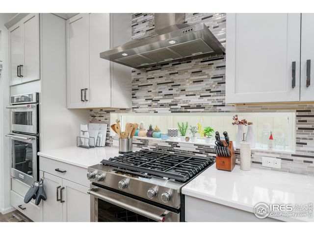a kitchen with stainless steel appliances granite countertop a stove and a sink