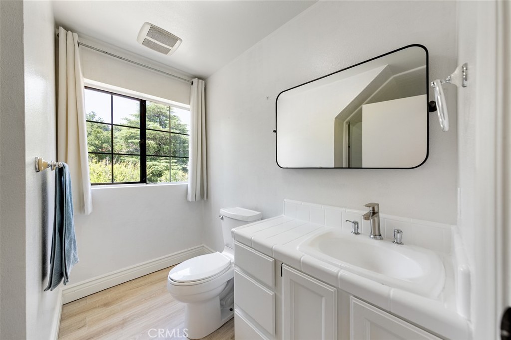 15601 Saddleback Road Canyon Country, CA 91387 - Photo 35 of 55 a bathroom with a sink a toilet and a mirror