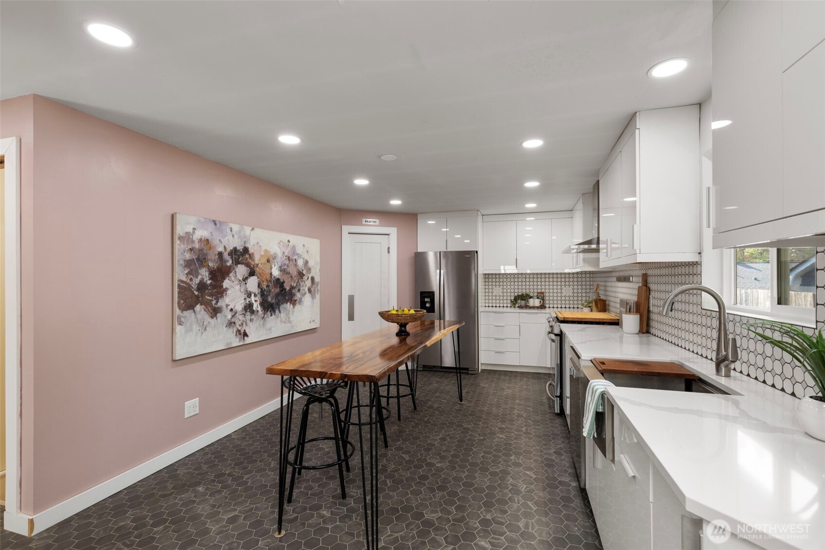 212 Willow Street Bremerton, WA 98310 - Photo 12 of 33 a kitchen with stainless steel appliances sink stove dining table and chairs