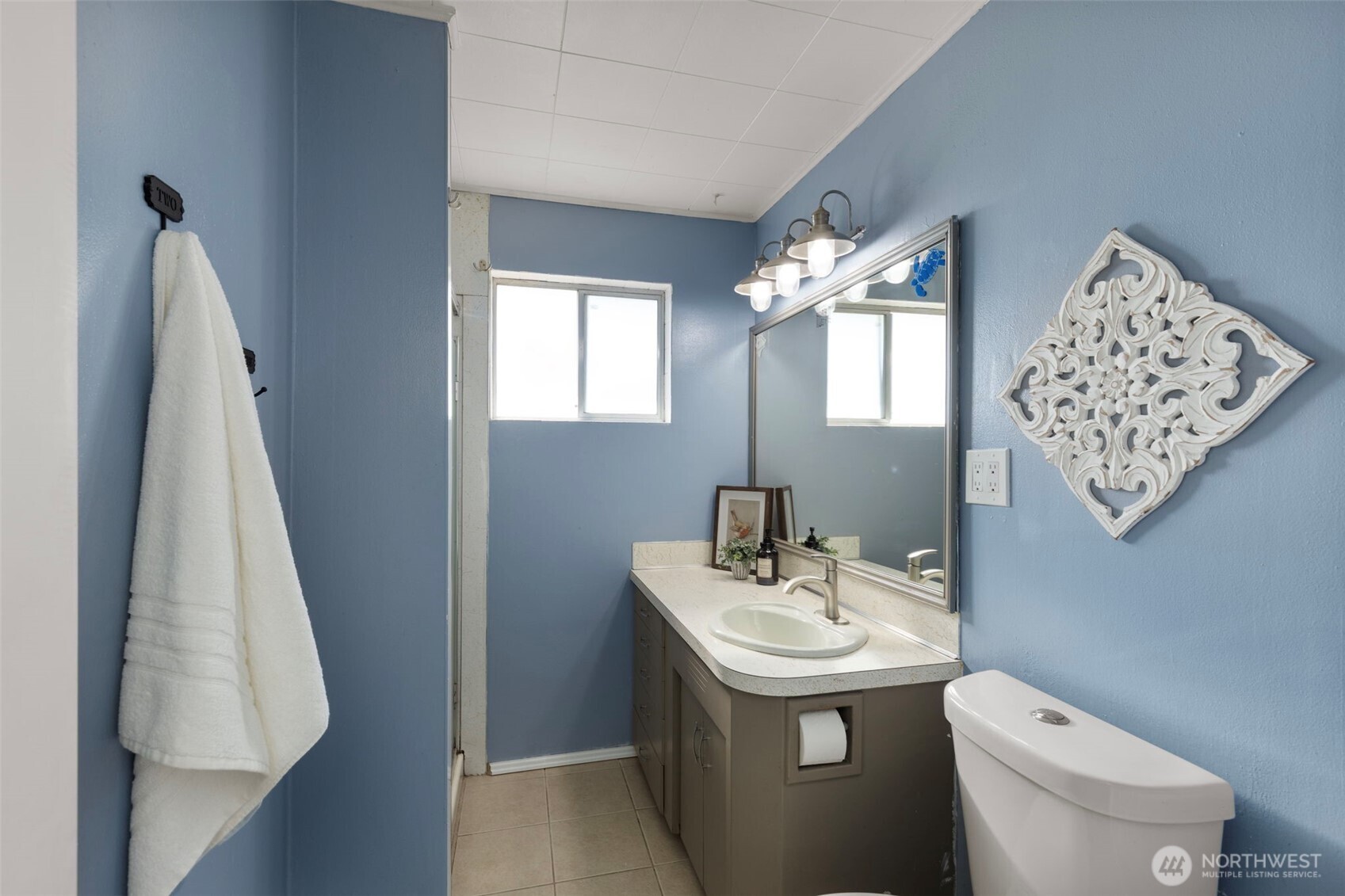 212 Willow Street Bremerton, WA 98310 - Photo 24 of 33 a bathroom with a sink and mirror with toilet