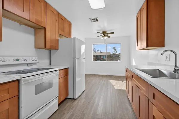 a kitchen with stainless steel appliances granite countertop a sink stove and refrigerator