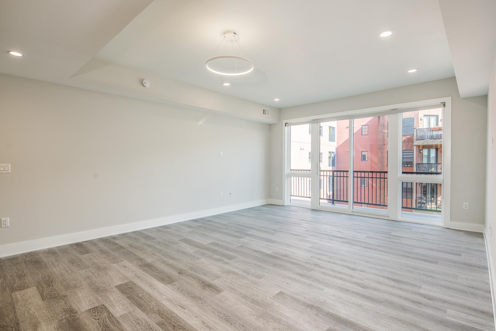 527 Monroe Street, Unit 3R Hoboken, NJ 07030 - Photo 12 of 22 wooden floor in an empty room with a window