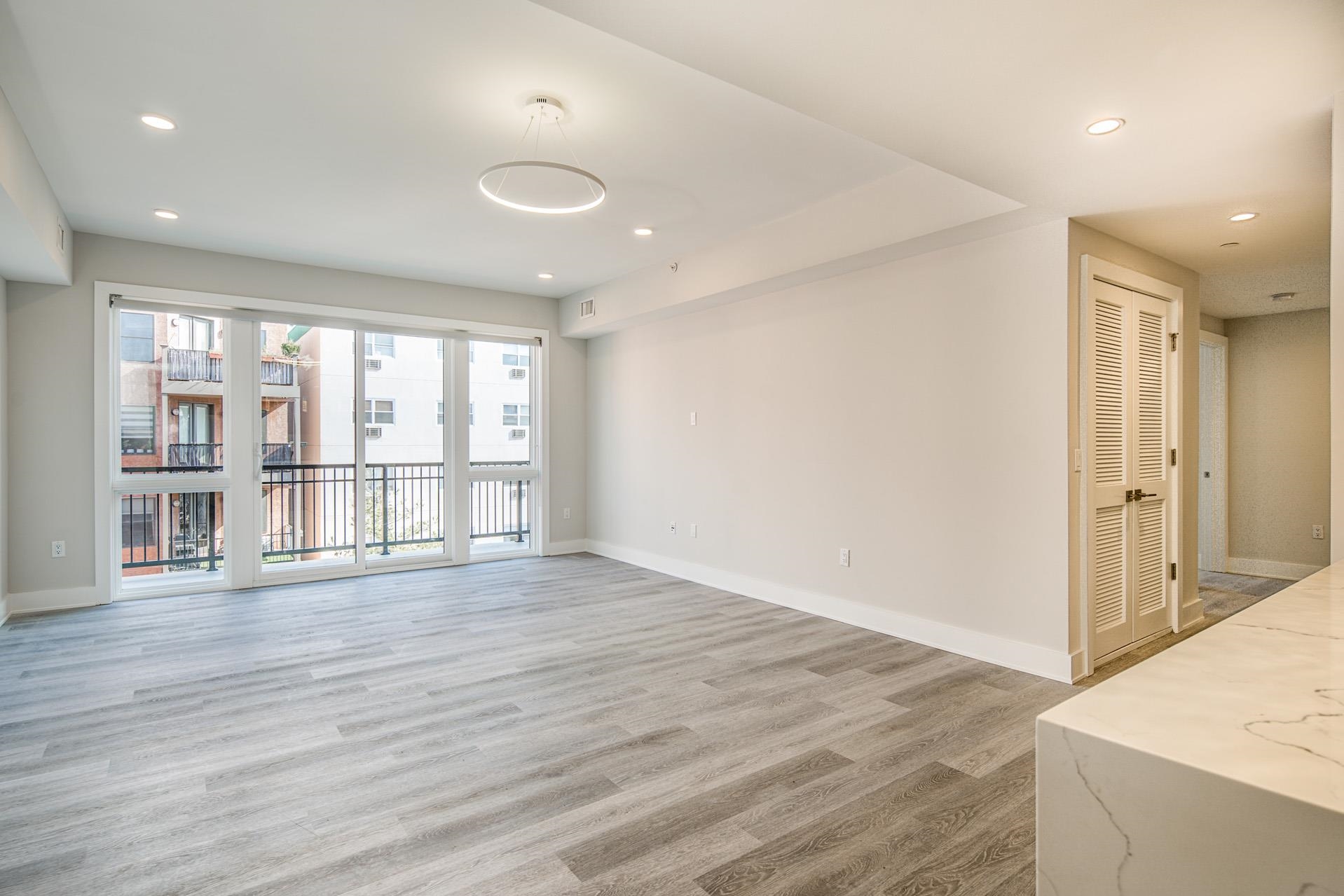 527 Monroe Street, Unit 3R Hoboken, NJ 07030 - Photo 13 of 22 a view of an empty room with wooden floor and a window