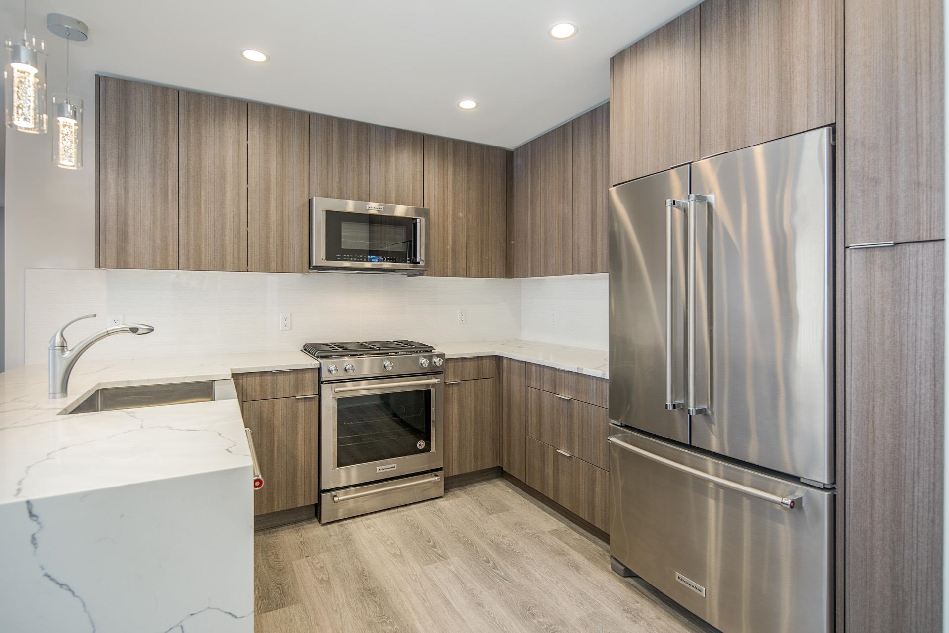 527 Monroe Street, Unit 3R Hoboken, NJ 07030 - Photo 15 of 22 a kitchen with granite countertop stainless steel appliances and wooden cabinets
