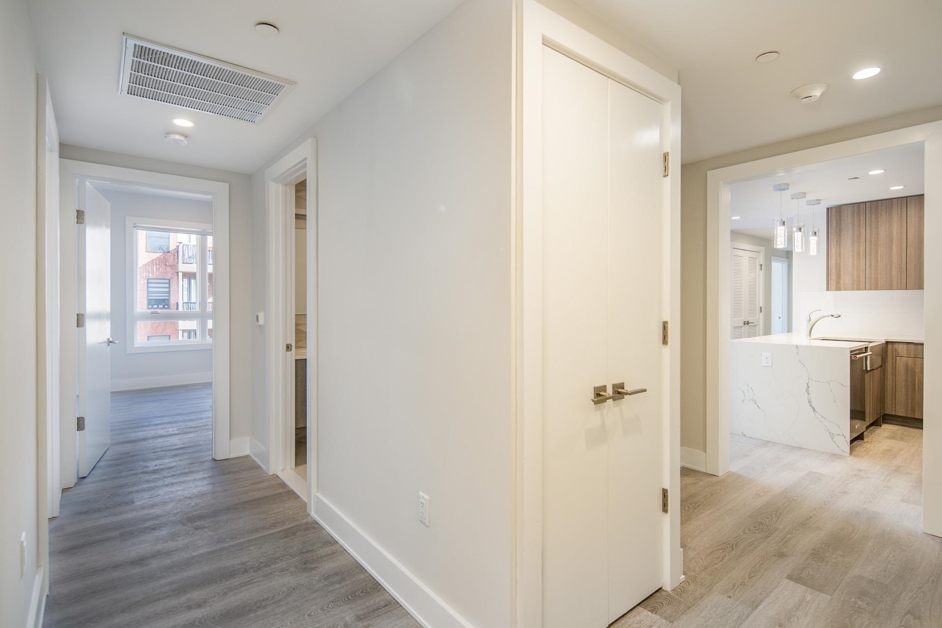 527 Monroe Street, Unit 3R Hoboken, NJ 07030 - Photo 16 of 22 a view of a hallway with wooden floor and a bathroom