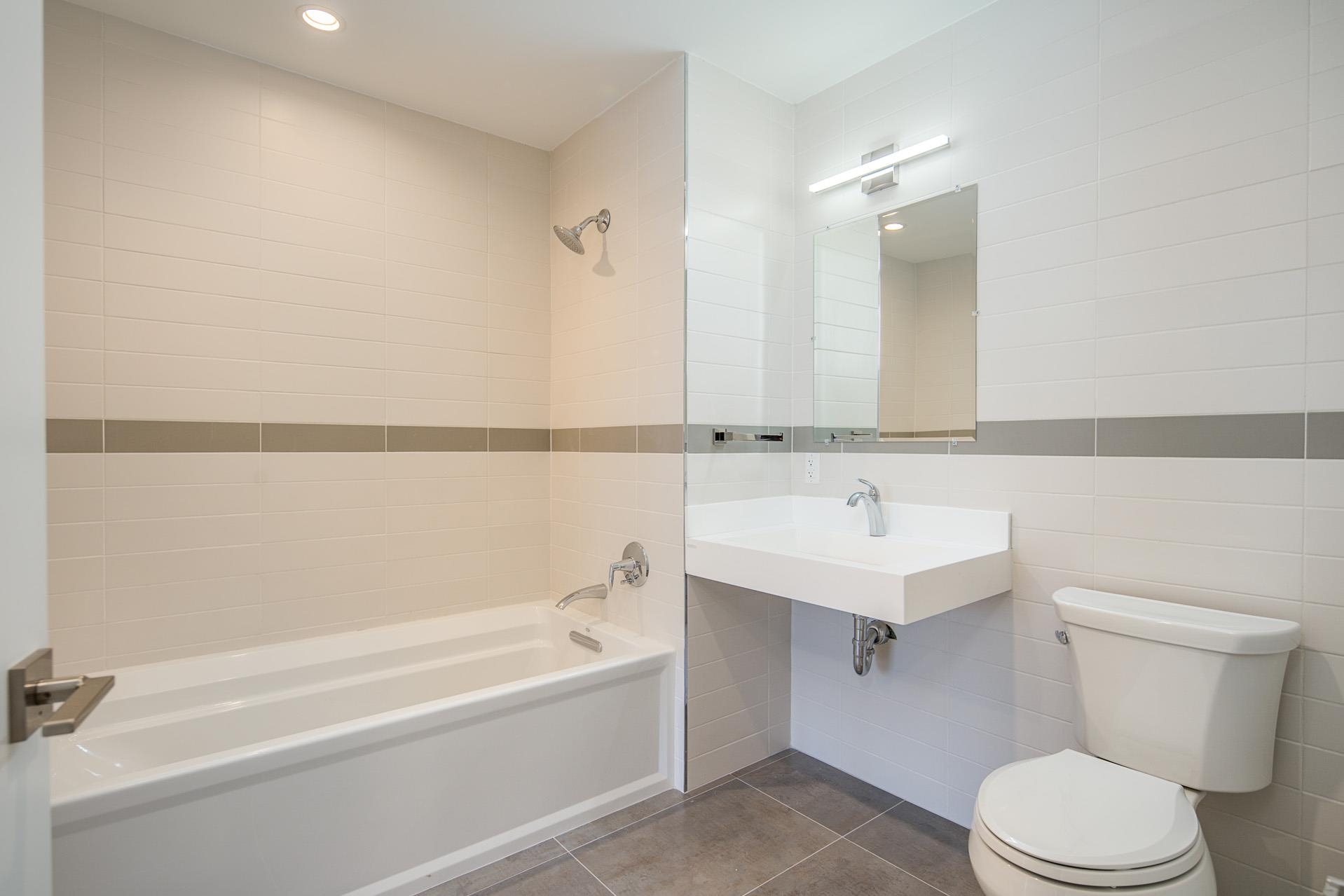 527 Monroe Street, Unit 3R Hoboken, NJ 07030 - Photo 7 of 22 a bathroom with a sink a toilet and shower