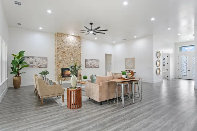 a dining room with furniture entryway and wooden floor