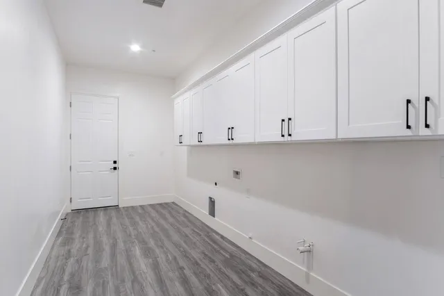 a kitchen with kitchen island granite countertop a sink cabinets and stainless steel appliances