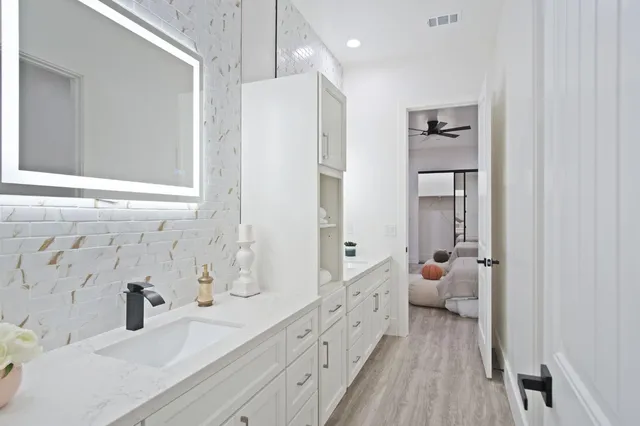 a living room with furniture a fireplace and wooden floor