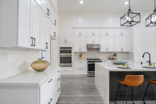 a bathroom with a double vanity sink a toilet and shower