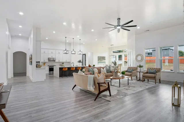 a living room with furniture and a wooden floor
