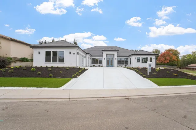 a view of house with a backyard