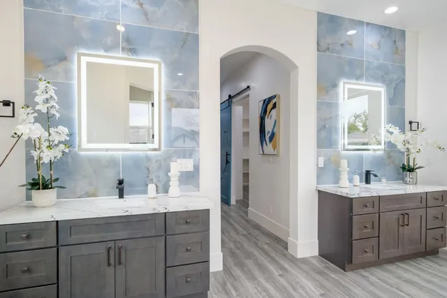 an aerial view of a house with outdoor space and a lake view in back