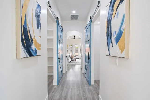 an aerial view of a house with outdoor space and a lake view in back