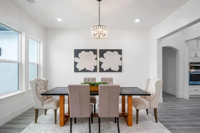 a dining room with furniture entryway and wooden floor