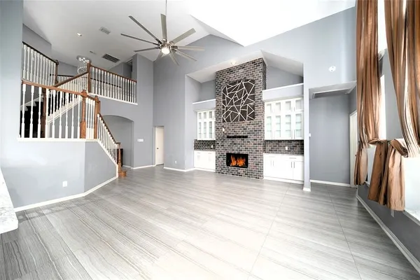 a view of a livingroom with wooden floor and a ceiling fan