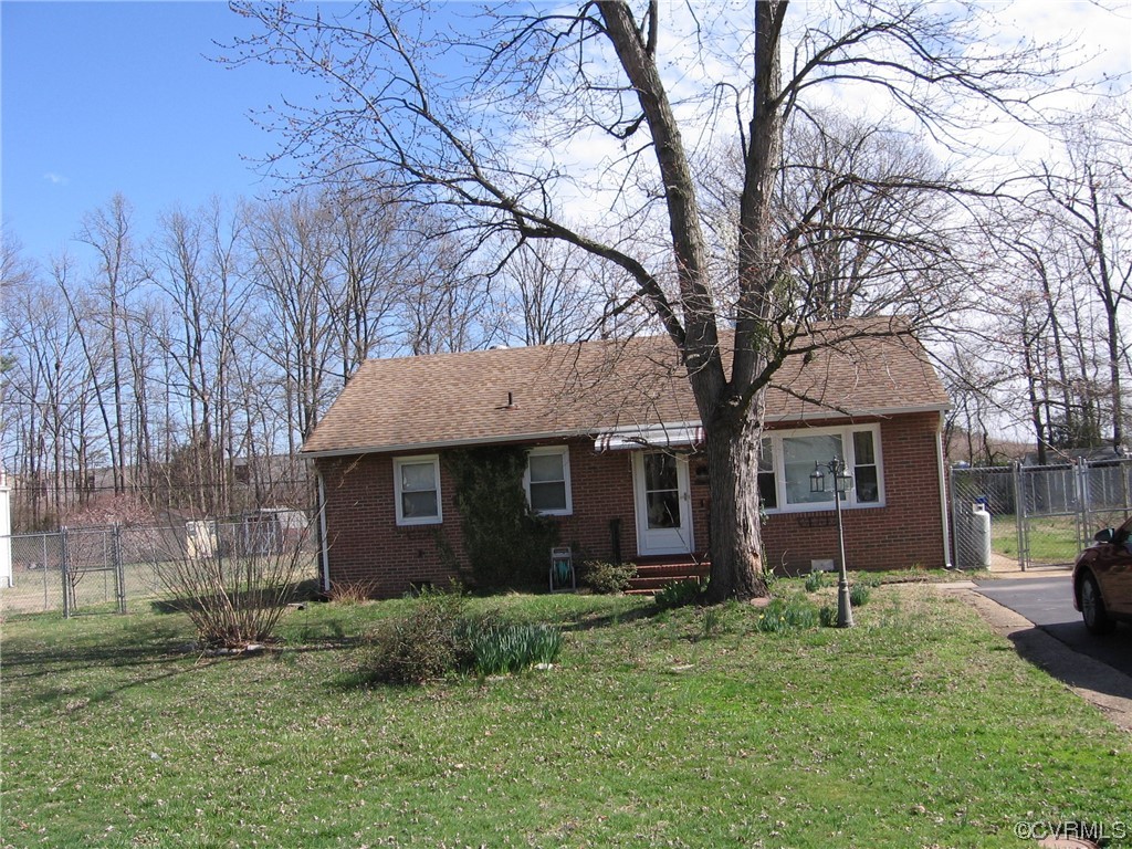 5415 Coxson Road Richmond, VA 23231 - Photo 1 of 14 a brick house with a large tree in front of it