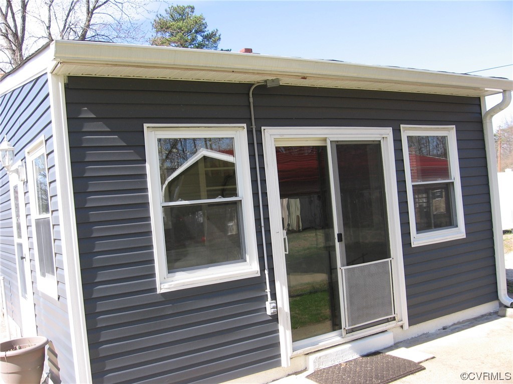 5415 Coxson Road Richmond, VA 23231 - Photo 4 of 14 a front view of a house with a glass door