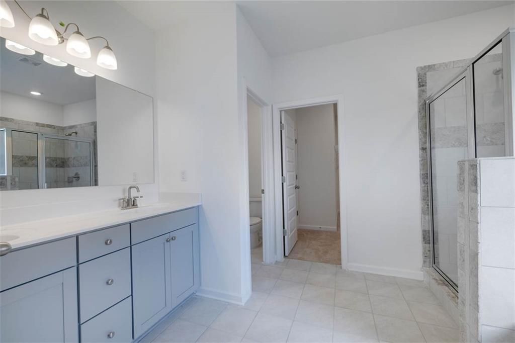 212 Umber Road Monticello, GA 31064 - Photo 11 of 30 a bathroom with a double vanity sink and mirror