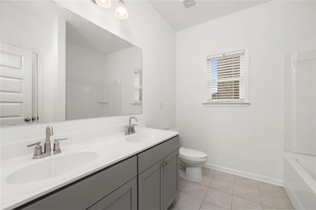 212 Umber Road Monticello, GA 31064 - Photo 21 of 30 a bathroom with a sink a toilet and a mirror