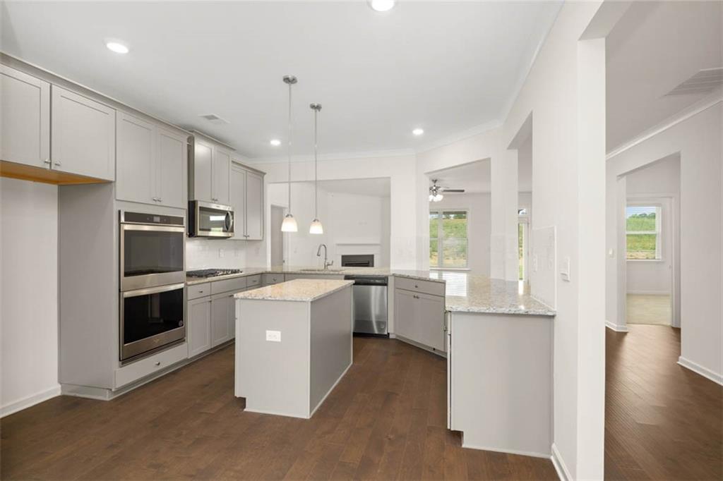 212 Umber Road Monticello, GA 31064 - Photo 6 of 30 a kitchen with white cabinets and stainless steel appliances