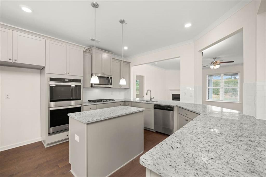 212 Umber Road Monticello, GA 31064 - Photo 7 of 30 a kitchen with stainless steel appliances granite countertop a stove sink and cabinets