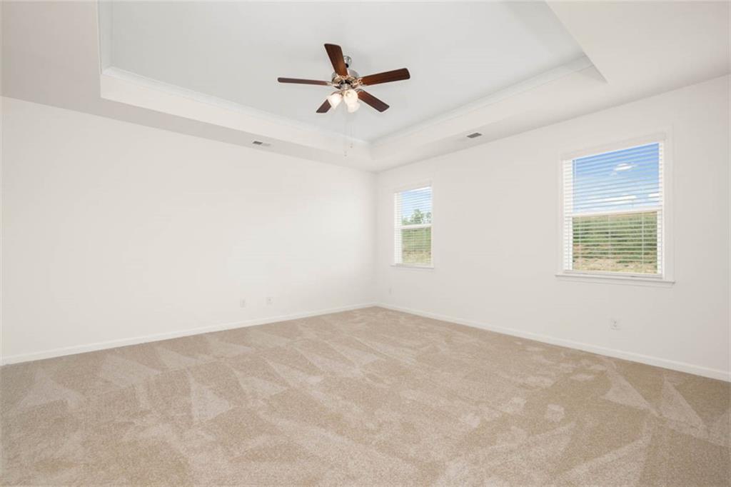 212 Umber Road Monticello, GA 31064 - Photo 9 of 30 an empty room with a ceiling fan and window