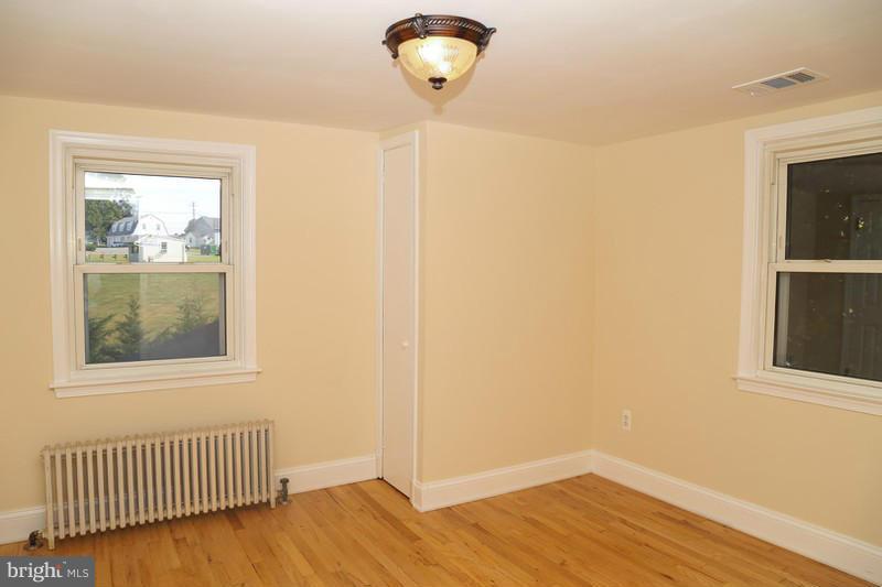 2429 Baldwin Mill Road Baldwin, MD 21013 - Photo 27 of 30 a view of an empty room with wooden floor and a window