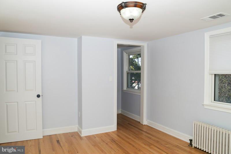 2429 Baldwin Mill Road Baldwin, MD 21013 - Photo 28 of 30 an empty room with wooden floor and windows