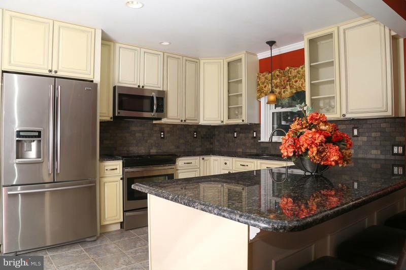 2429 Baldwin Mill Road Baldwin, MD 21013 - Photo 4 of 30 a kitchen with stainless steel appliances granite countertop a refrigerator sink and microwave